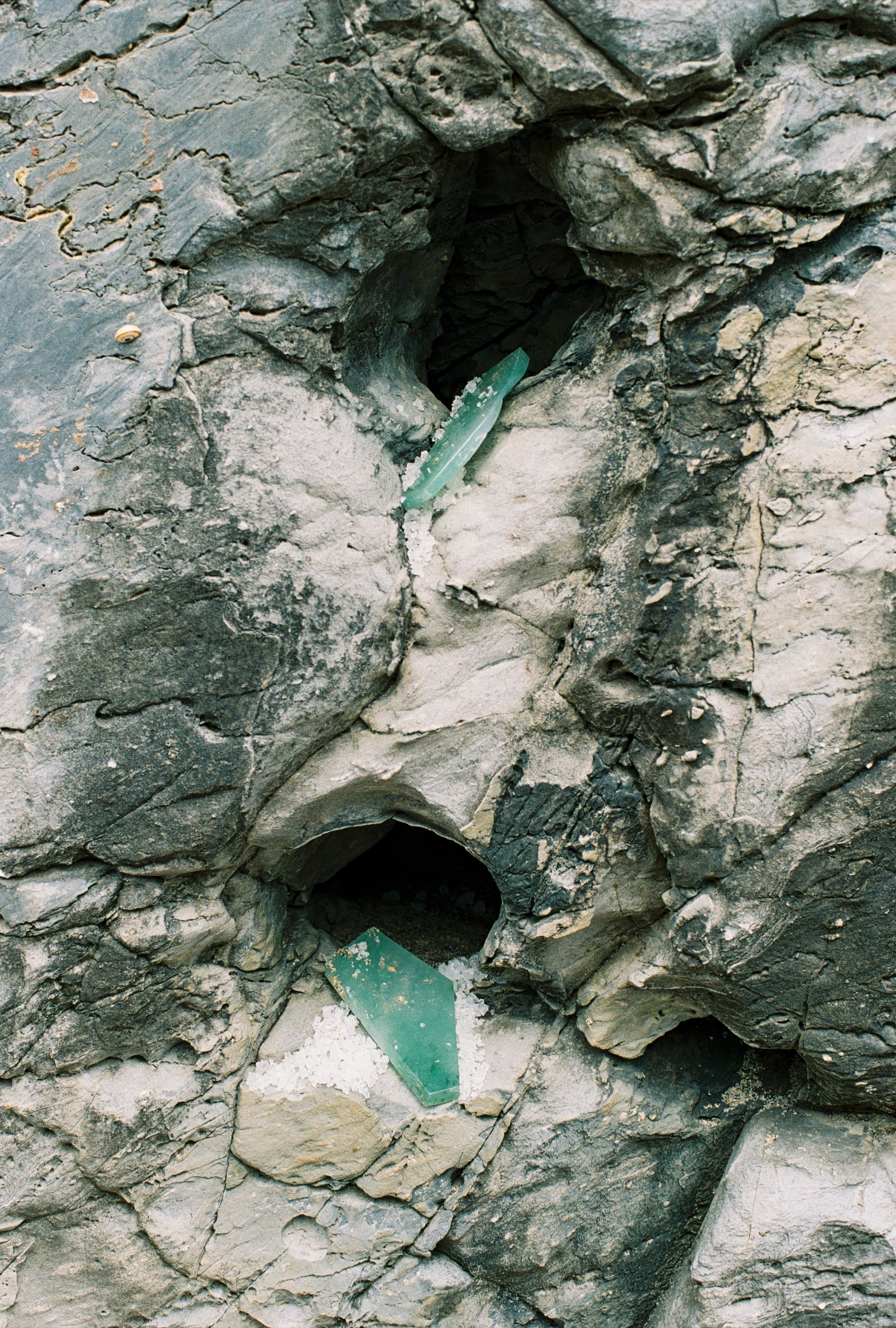 Veins of green jadeite running through pale rock
