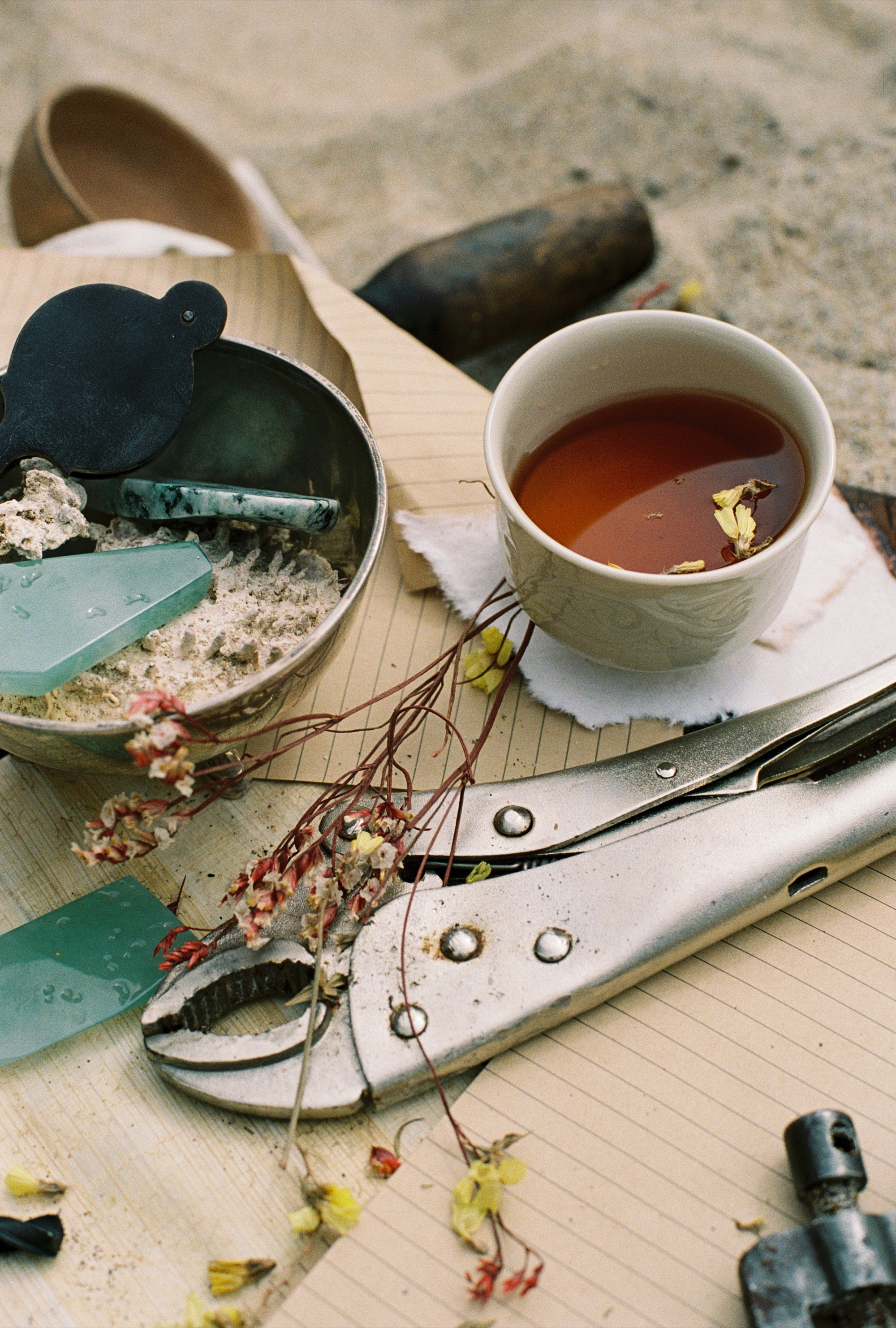 A still life with tea, jadeite and tools in warm light